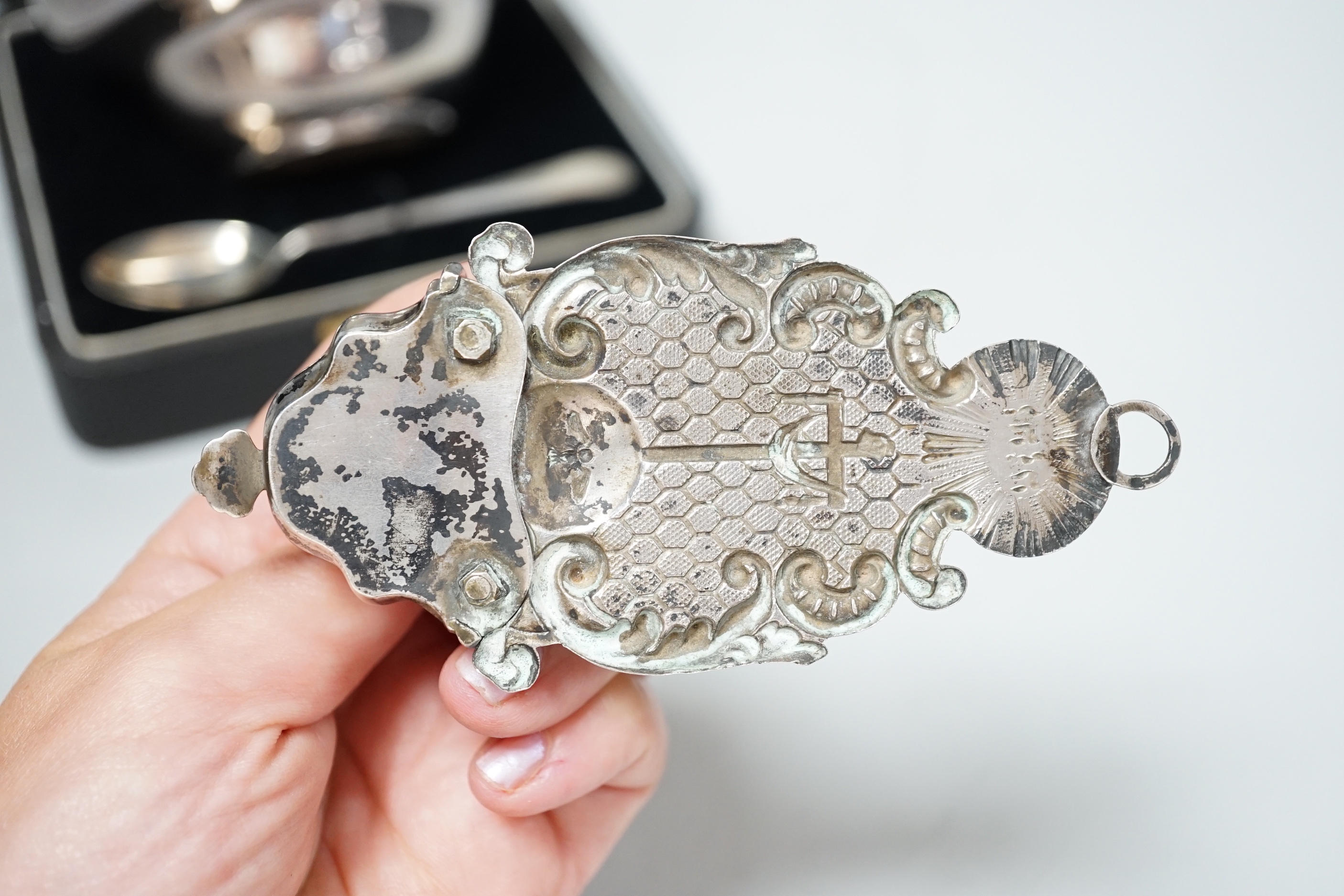 An early 19th century Viennese repousse white metal holy water stoup, 11.4cm, together with a cased 1930's silver spoon and mounted silver bowl.